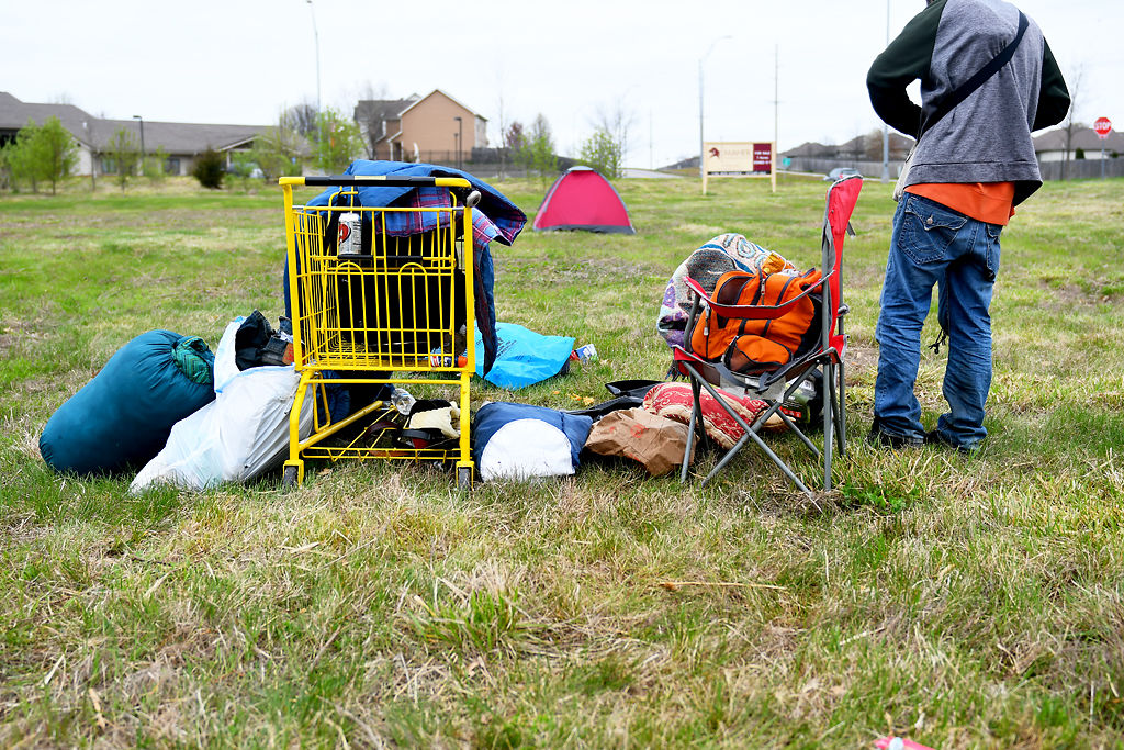 A homeless man packs up his belongings